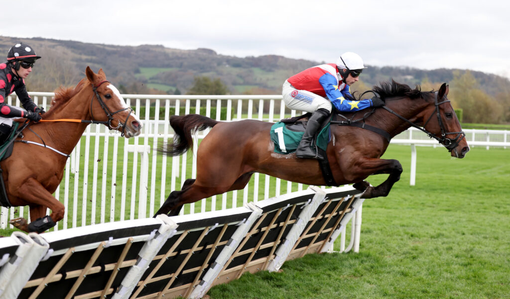 Ace Of Spades jumps a hurdle en-route to winning at Cheltenham under Harry Skelton.